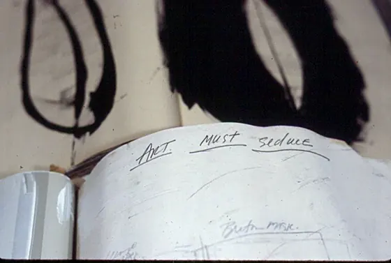 A page with black painted forms and handwriting across the top.