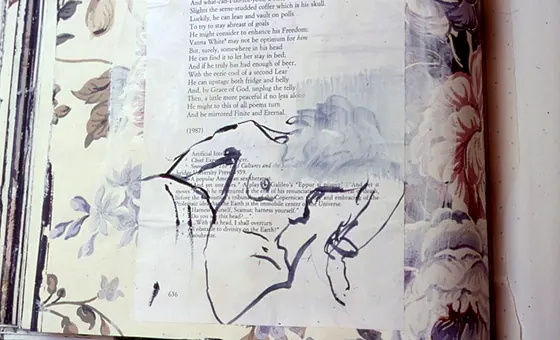 An open book with pale floral paper and a large looping ink drawing.
