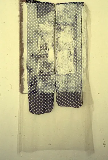 Construction Installation 6: gauze and polka-dot fabric hanging against a pale wall.