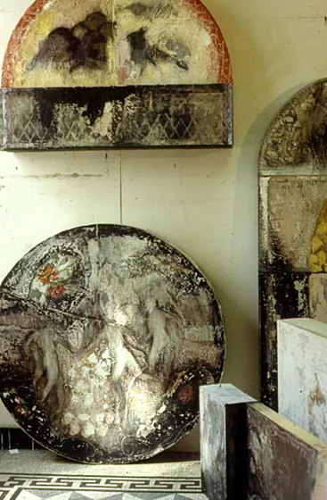 Nothing Sacred Nothing 3: round and arched textured panels leaning against a wall above a tiled floor.